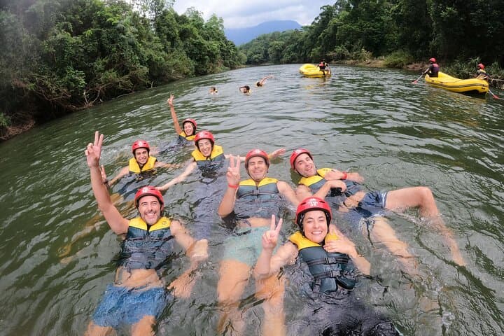 Group of guests relaxing and swimming in the Kelani River during a Kithulgala camping and adventure package