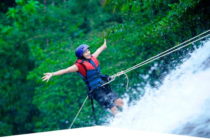 Adventurer abseiling down a waterfall in the Makandawa rainforest near Kithulgala