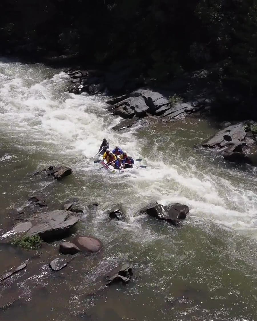 Guided white-water rafting group navigating rapids on the Kelani River in Kithulgala